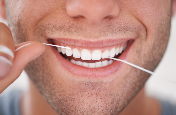 Man flossing teeth