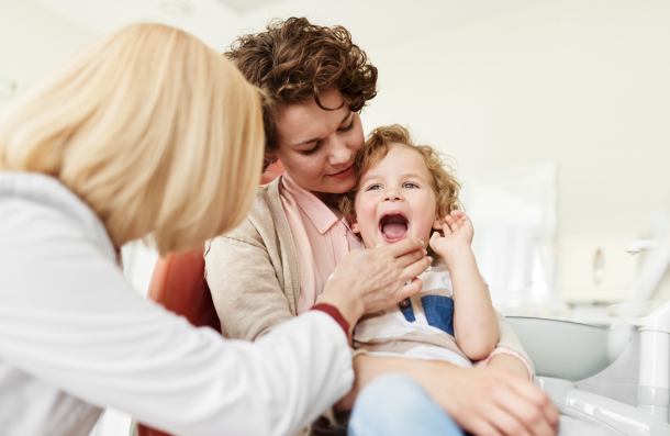 Children's Dentistry child sat on mums lap at dentist