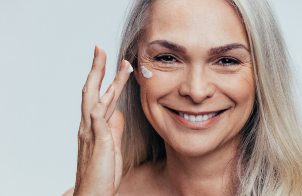 elderly lady puting on face cream