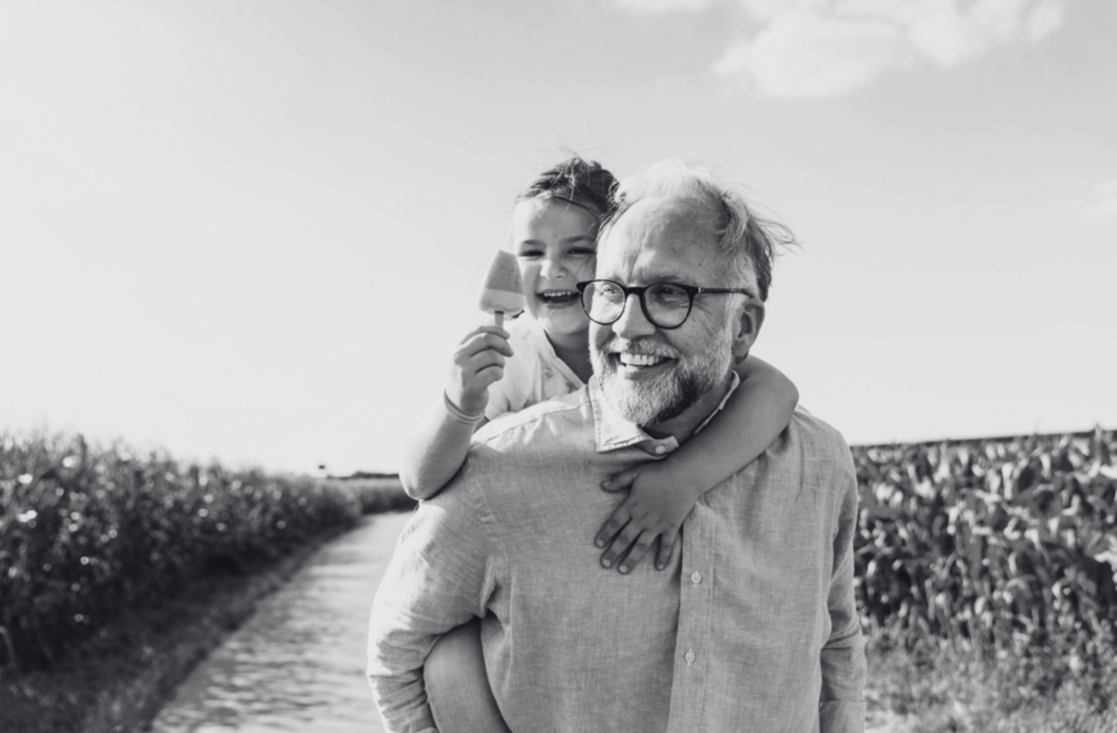 Modbury home man with child on back eating ice cream